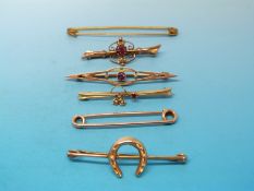 Three yellow metal brooches marked 9ct set with garnets and seed pearls,