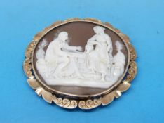 A cameo brooch depicting a classical scene in yellow metal floral surround