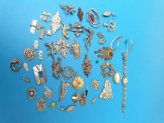 A quantity of silver/white metal brooches to include marcasite,