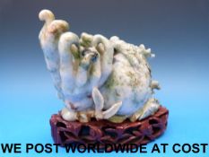 A Chinese jadeite carved brush pot in the form of a Buddha's hand fruit carved in relief with