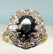 An 18ct gold ring set with a sapphire surrounded by diamonds (size P)