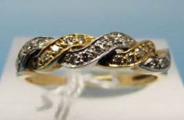 An 18ct bi-coloured gold ring set with diamonds (size R)