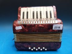 A Hohner 'Mignon' child's piano accordion in red pearloid finish