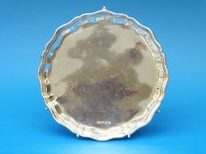 A hallmarked silver salver with shaped edge,