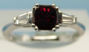 A platinum ring set with a laboratory grown red diamond of approximately 0.