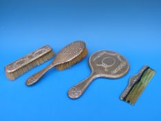 A four piece hallmarked silver mounted Neoclassical style dressing table set comprising hand mirror,