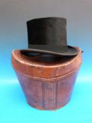 A silk top hat in a leather case