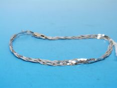 A white metal plaited bracelet marked 750 (3.