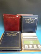 Three albums presentation packs and two albums of royal family stamps