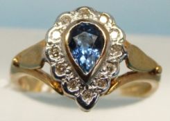A 9ct gold ring set with a central tear drop shaped topaz surrounded by diamonds (size L)