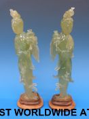 A pair of bowenite Chinese figures on wooden plinths with inscription to base 