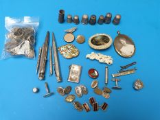 Two bone brooches, seven white metal/ silver thimbles, Chinese silver cane top, enamelled pendant,