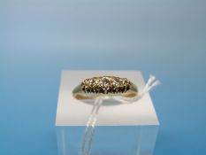 A yellow metal ring marked 18ct set with five diamonds (size O)