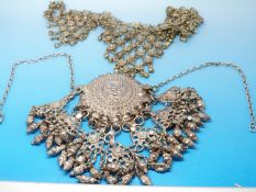 A large silver necklace (Tibetan) and an early 20thC chain link necklace with simulated pearl