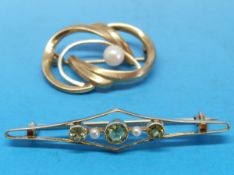 A 9ct gold brooch set with a pearl together with a 14ct gold brooch set with peridot and seed