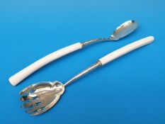 A pair of Victorian hallmarked silver ivory handled salad servers with engraved bowls,