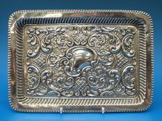 A silver repoussé decorated tray, Birmingham, maker WH (weight 270g, length 27.
