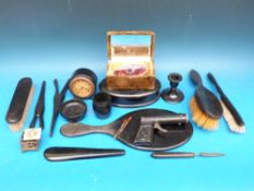 A collection of ebony dressing table items including an ebony clock etc