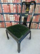 A Chinese ebonised chair with gilt decoration of a pagoda to the shaped splat and drop in