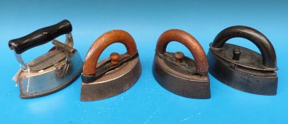 Four lozenge shaped smoothing irons with detachable handles or slugs including Jas.