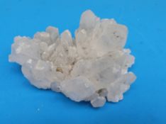 A small geological sample formed of variously sized partially translucent grey crystals,