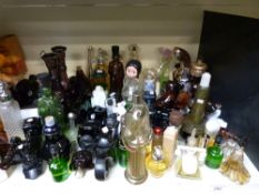 A large collection of Avon scent bottles including novelty examples