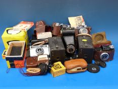 A collection of vintage cameras including folding Brownie,