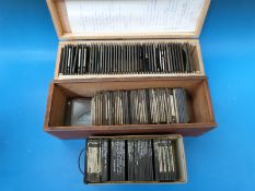 A collection of magic lantern slides in cases to include sculptures, ships, Niagara Falls,