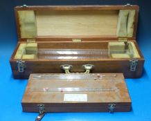 A cased set of four glass pipettes, up to one fl oz together with a cased 0.