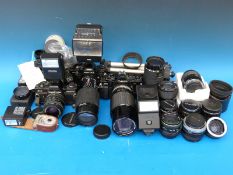 A quantity of SLR cameras and lenses etc, to include Praktica, Canon,