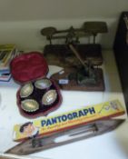 A large set of postage scales, vintage hole punch, a pantograph,