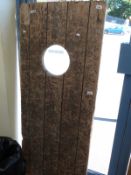 A probably teak ship's door,
