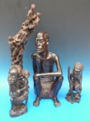 A large well-carved African tribal elder in a seated position (46cm high),