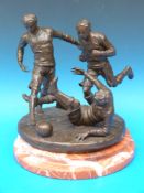 A bronze of three possibly 19thC footballers, on shaped marble base,