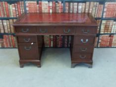 A twin pedestal desk with eight drawers,