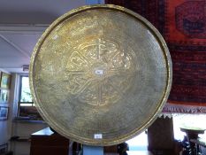 A large intricately inscribed brass tray, 75cm in diameter,