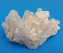 A small geological sample formed of white crystals scattered with fools gold to the bottom