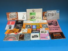 A mix of vintage camera manuals to include Nikon and Canon