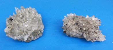 Two geological samples, one larger, formed of small narrow grey crystals,