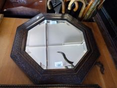 An oak framed octagonal mirror