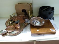 A collection of copper and brassware together with a set of fire bellows, cast pots, records,