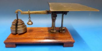 An unusual set of likely W&T Avery parcel scales on a mahogany base,