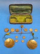 A shagreen cased set of travelling beam scales with a quantity of various coin weights