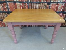A pine kitchen table with pink painted legs (L122 x W85 x H77cm)