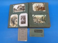 A vintage postcard album containing a collection of postcards Victorian onwards,