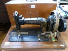 A Frister & Rossmann sewing machine with inlaid wooden case