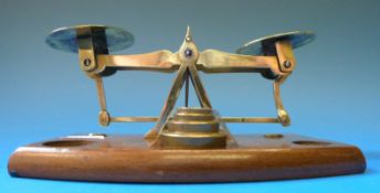 A set of brass postage scales on wooden base with weights