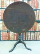 A 19thC mahogany tilt top circular table raised on a tripod base,