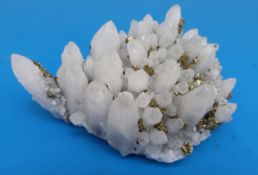 A geological sample formed of partially translucent crystals with scattered fools gold between