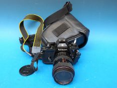 A Nikon EM SLR camera with Tokina lens,
